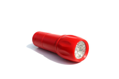 Red flashlight lies on a white backgroundの写真素材