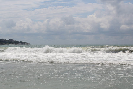 Restless stormy sea. Summer cloudy cool day.