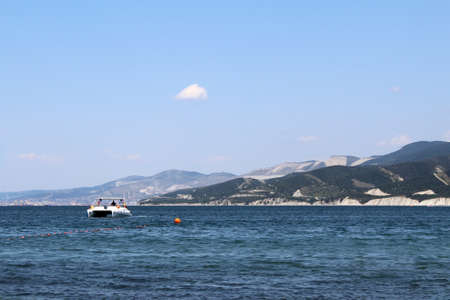 Seascape. Water transport floats on the waves. Sunny hot day.の写真素材