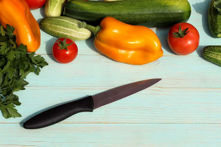 There is a knife on the table surrounded by vegetables. Preparing to cook dinner.の写真素材