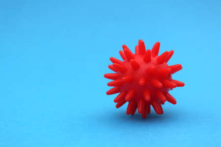 Red mock-up of coronavirus on a blue background with place for text.の写真素材
