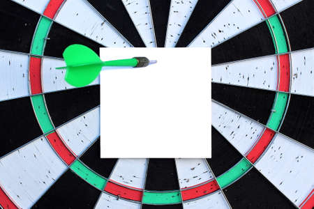 In the middle of the circle, a reminder sheet is attached to the darts game and attached with a dart.の写真素材