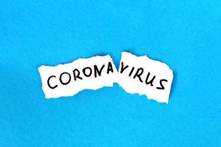Coronavirus is written on white paper on a blue background.の写真素材