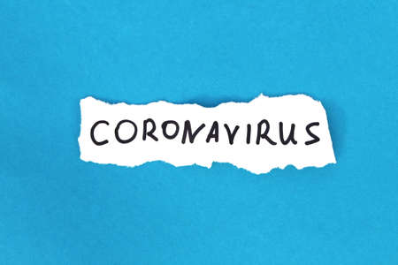 Coronavirus is written on white paper on a blue background.の写真素材