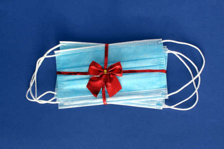 Medical masks are packed in a bow as a gift.の写真素材