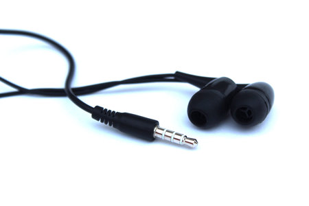 Headphones black small lie on a white isolated background.の写真素材