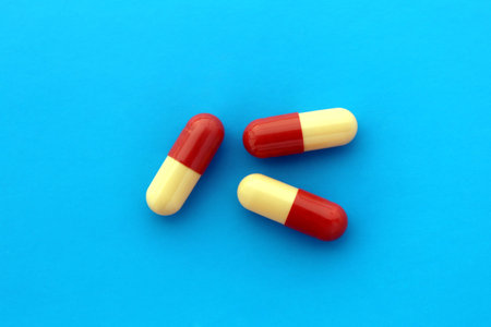 Three medicines in a capsule lies on a blue background