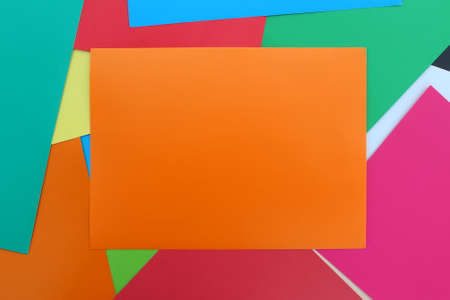 Colored paper is laid out on a flat surface. Multicolor bright abstract background. Place for text.の写真素材