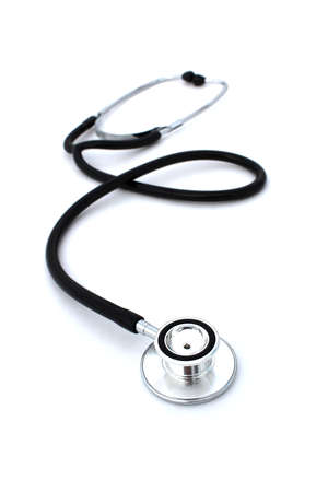 On a white isolated background lies a black stethoscope.の写真素材