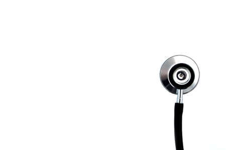 On a white isolated background lies a black stethoscope.の写真素材