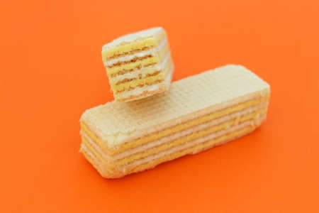 Two waffles lie on an orange backgroundの写真素材