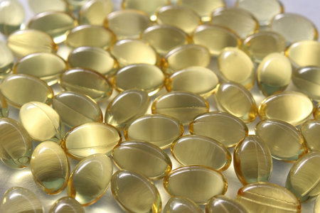 Background, capsules of vitamin D transparent yellow.