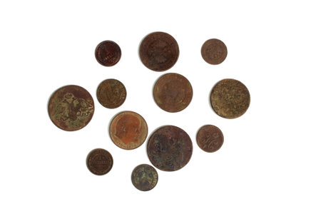 Antique round dirty coins lie on a white background.の写真素材