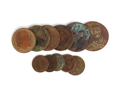 Antique round dirty coins lie on a white background.の写真素材