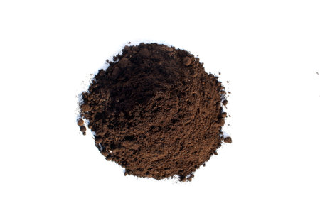 A pile of soil for seedlings lies on a white background.の写真素材