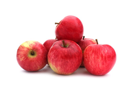 A bunch of red apples lies on a white background.の写真素材