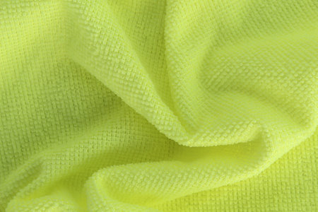 A green cleaning rag lies on a white isolated background. texture.の写真素材