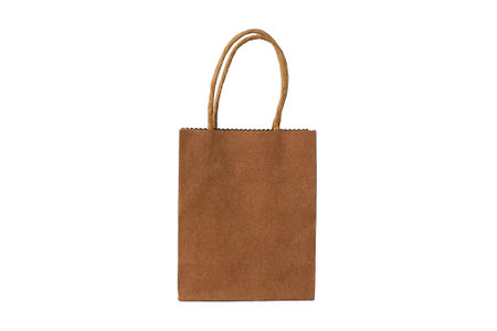 On a white background is a paper bag with a brown handle.の写真素材