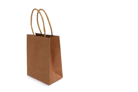 On a white background is a paper bag with a brown handle.の写真素材