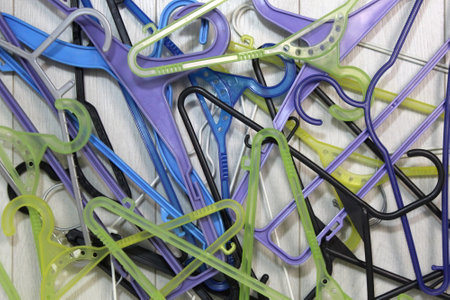 A bunch of plastic hangers are in one pile.の写真素材