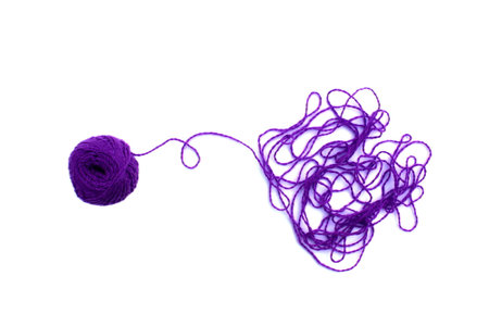 Entangled threads with a ball lie on a white background.の写真素材