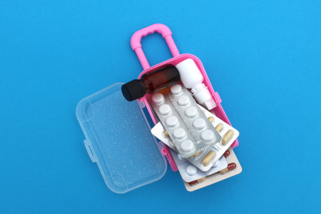 Medicine pills are on a miniature suitcase.の写真素材