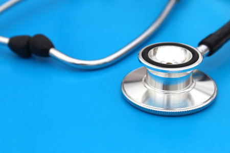 the stethoscope lies on a blue background. The topic is medicine.の写真素材