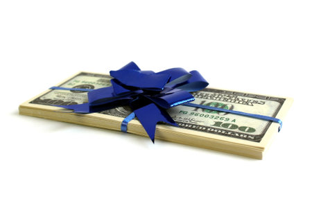 On a bright background lies a homemade plane made from dollar bills.の写真素材
