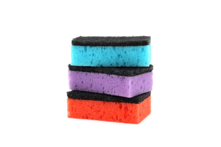A stack of multi-colored sponges is on a white isolated background.の写真素材