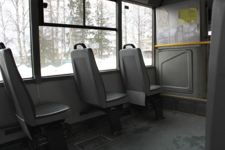 The interior of the bus with seats, winter outside.の写真素材