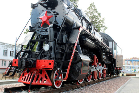 The retro train stands on the rails.