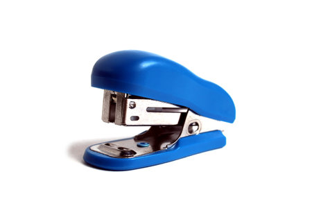 A blue small office stapler is located on a white background.の写真素材