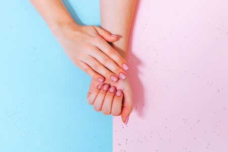 Female hands with manicure on paperの写真素材
