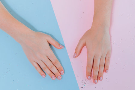 Female hands with manicure on paperの写真素材