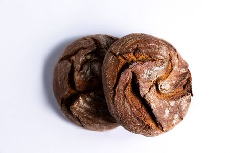 Two round loaves of rye bread on the table. Flatlay style. Taken from above. Isolated white.の写真素材