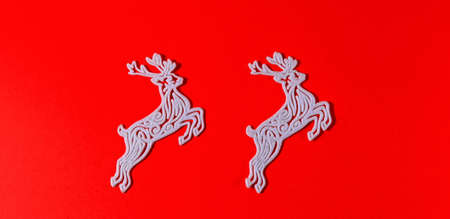 Figure of a Christmas decoration on a red solid background. New year's deer. Festive ornament. Copyspace.の写真素材