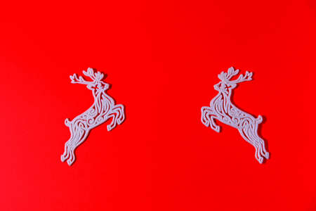 Figure of a Christmas decoration on a red solid background. New year's deer. Festive ornament. Copyspace.の写真素材