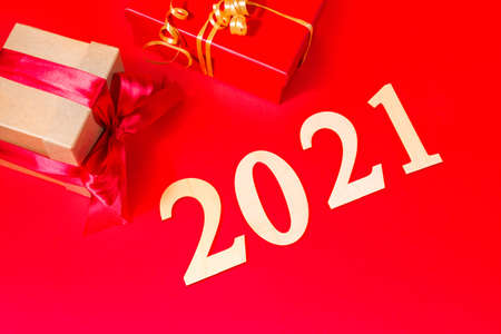 Holiday boxes with gifts on a red background. 2021 symbols of the year. Holiday banner with gifts.の写真素材