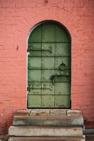 green door in the red wallの写真素材