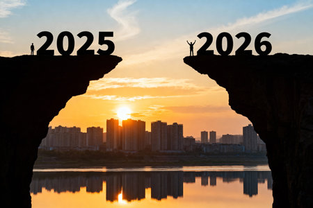 A striking image shows two figures standing on cliffs, separated by a gap, with the numbers 2025 and 2026. The background features a city skyline and a vibrant sunset.の素材