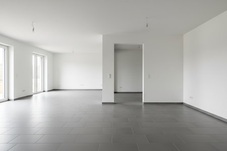 This spacious, minimalist interior features large windows and a bright, airy atmosphere, perfect for various design conceptsの写真素材