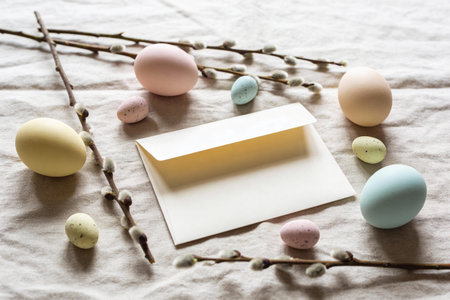A collection of pastel-colored Easter eggs and soft pussy willow branches are artfully arranged...