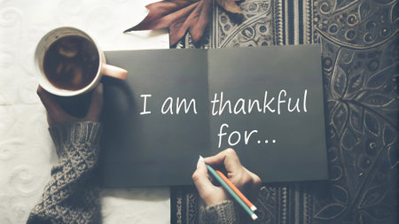 Minimalistic gratitude journal with handwritten 'I am Thankful for' in a cozy autumn setting. Ideal for Thanksgiving-themed visuals, wellness ads, or personal development campaignsの写真素材