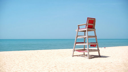 Beach lifeguard post on a beautiful sandy shore with clear blue water in the background. Works well for travel photography, ocean safety awareness, or adventure tourism ads.の素材