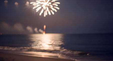Bright fireworks burst in the night sky above calm ocean waters, with colorful reflections shimmering on the surface, enhancing the festive ambiance of the sceneの写真素材