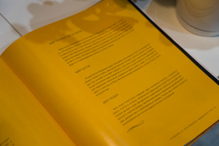 Odesa, Ukraine - July 30, 2024: Open book featuring yellow pages with text about mapping processes, highlighting educational design and informative contentの写真素材