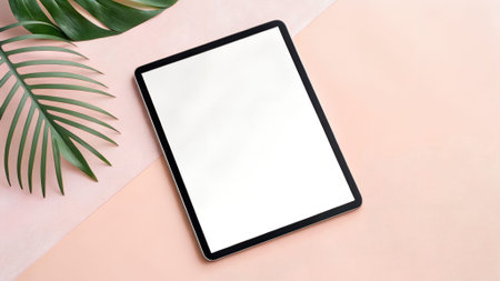 Digital tablet mock up features a blank screen on a soft pink surface, complemented by lush palm...