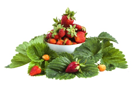 strawberries in a bowl and leaves isolated on white backgroundの写真素材