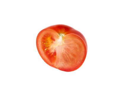 half a tomato isolated on white backgroundの写真素材