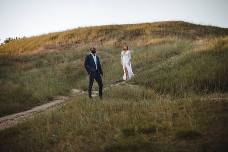 happy and beautiful mixed ethnicity couple with beautiful afro American man and cheerful european woman looking in different directionsの写真素材